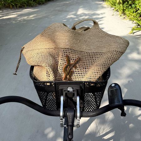 @hannahstraffordtaylor picture of bicycle basket with saint laurent raffia beach bag inside