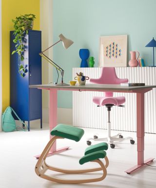 Pink chair and standing desk, yellow and blue walls