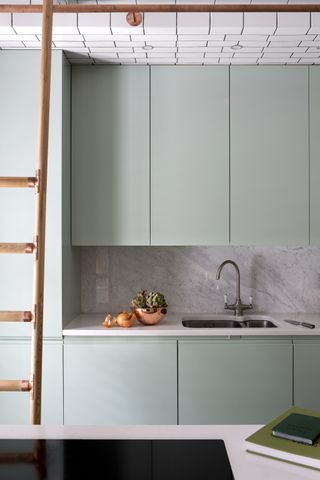 Pale blue kitchen with subway tiled ceiling