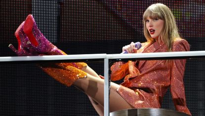 Taylor Swift performs at the Eras Tour wearing a pair of custom Louboutin boots