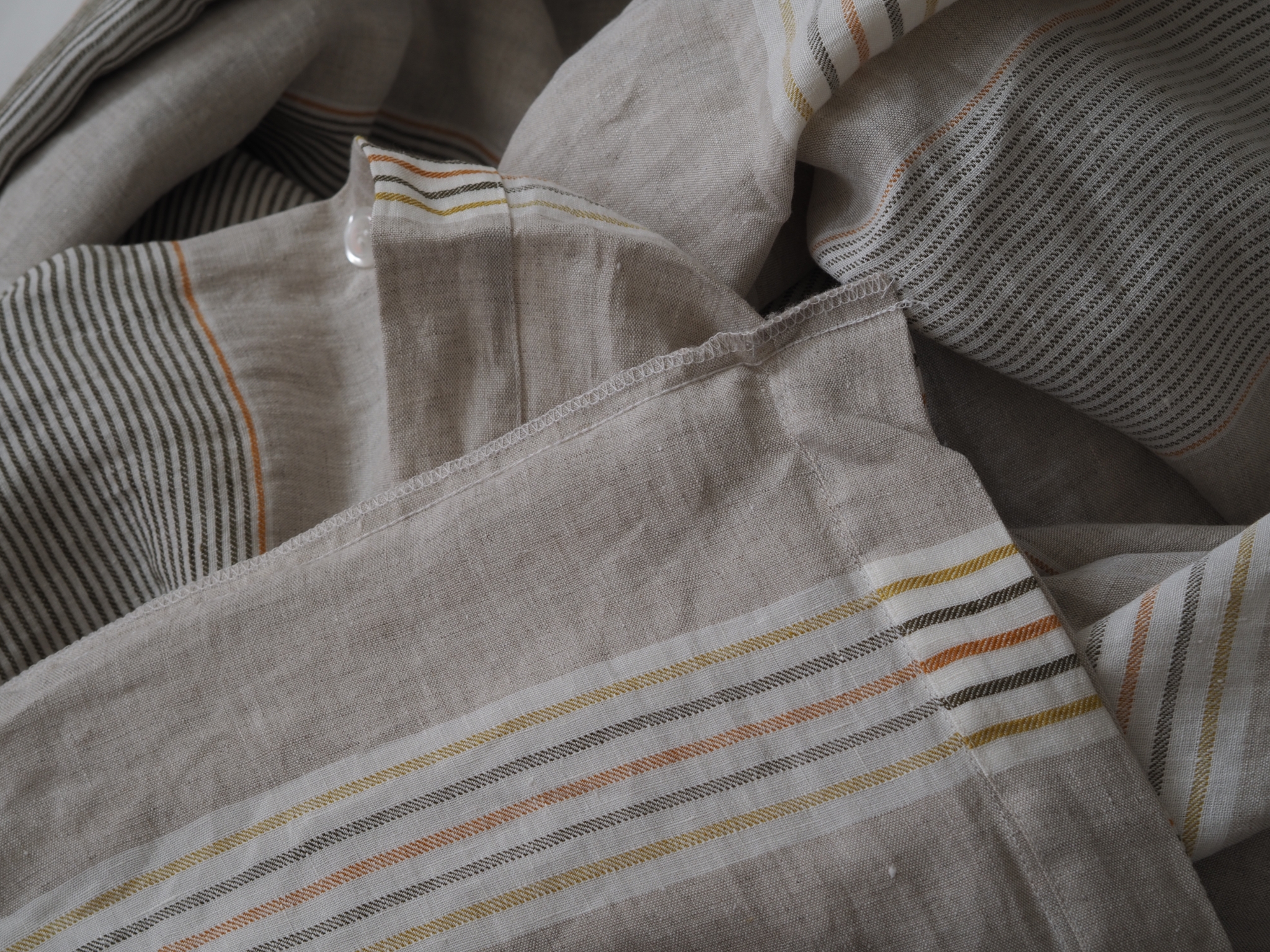 inside the seams of striped linen bedding