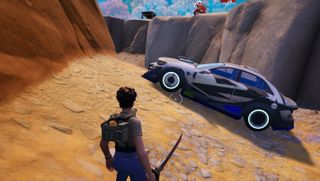 Fortnite - a player stands in front of a blue and white Nitro Drift car