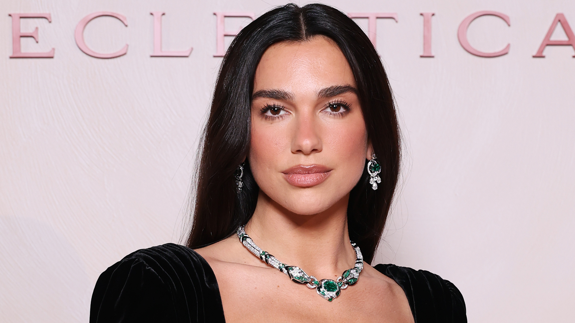 Dua Lipa attended a Bulgari event in Milan dressed in a peekaboo bra dress from Balmain