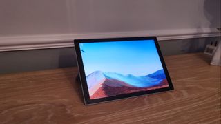A Microsoft Surface Pro 7 Plus on a wooden table