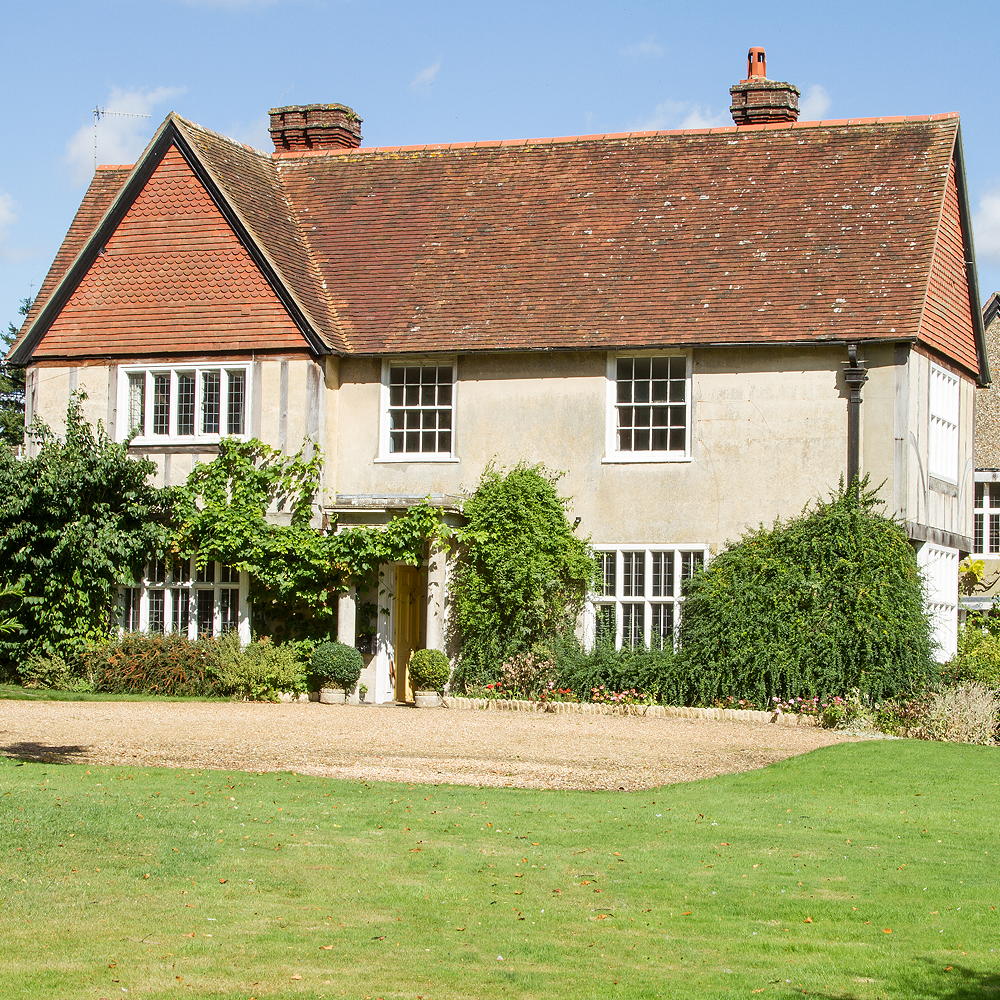 house exterior with lawn and white window and yellow door