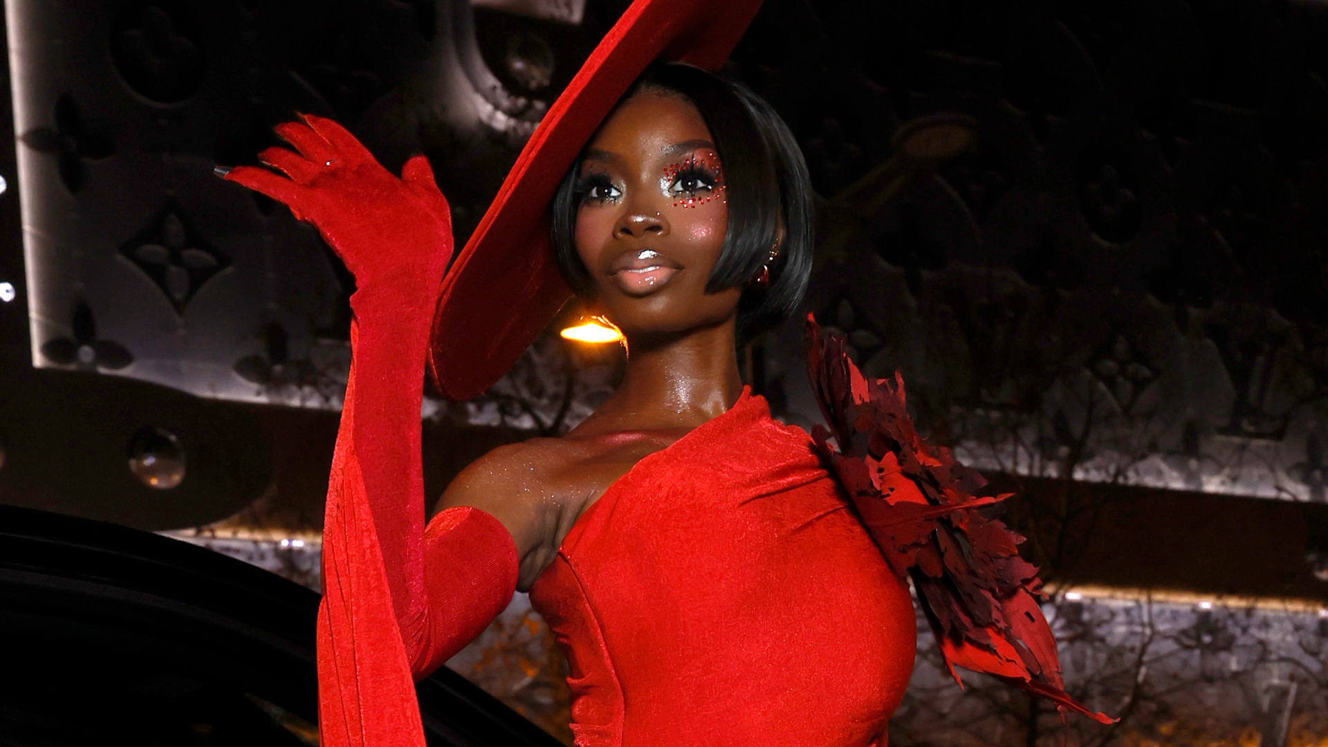 Olandria Carthen returned to Paris Couture Week wearing a red Robert Wun jumpsuit and matching hat