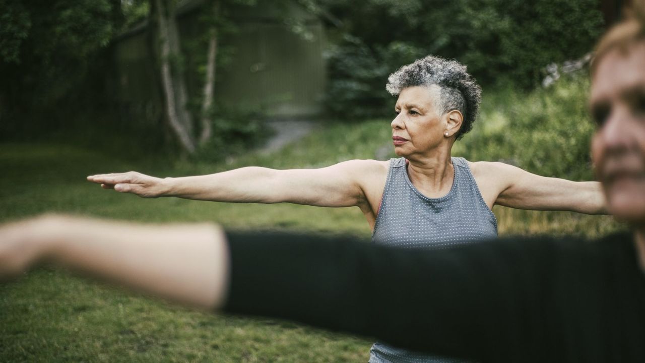 Woman with short hair practices yoga outdoors