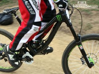 Monster Energy-Specialized gave Sam Hill's new race bike a stealthy black finish but we still noticed the new carbon fiber front triangle.