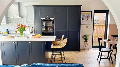 open plan kitchen and dining area with rattan bar stools