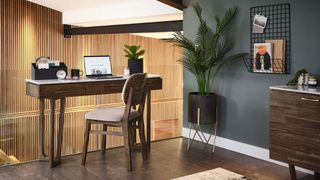 landing home office with green wall and glass balustrade