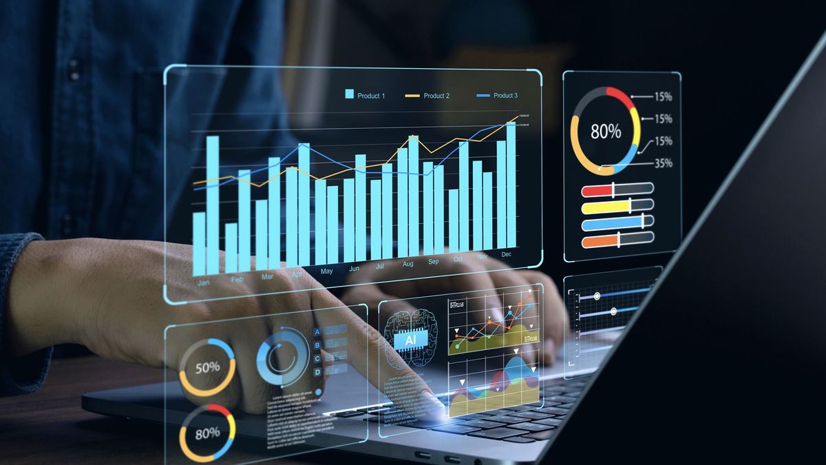 Business analytics graphics overlayed on image of someone using a laptop