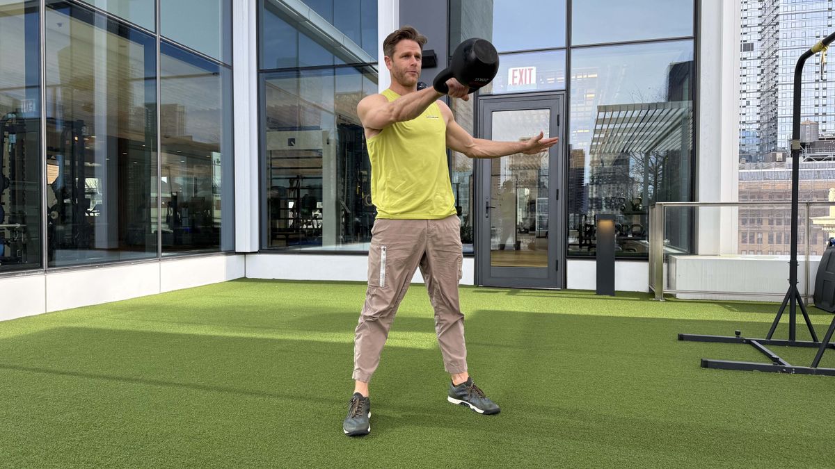 a photo of Peloton trainer Andy Speer doing a kettlebell swing