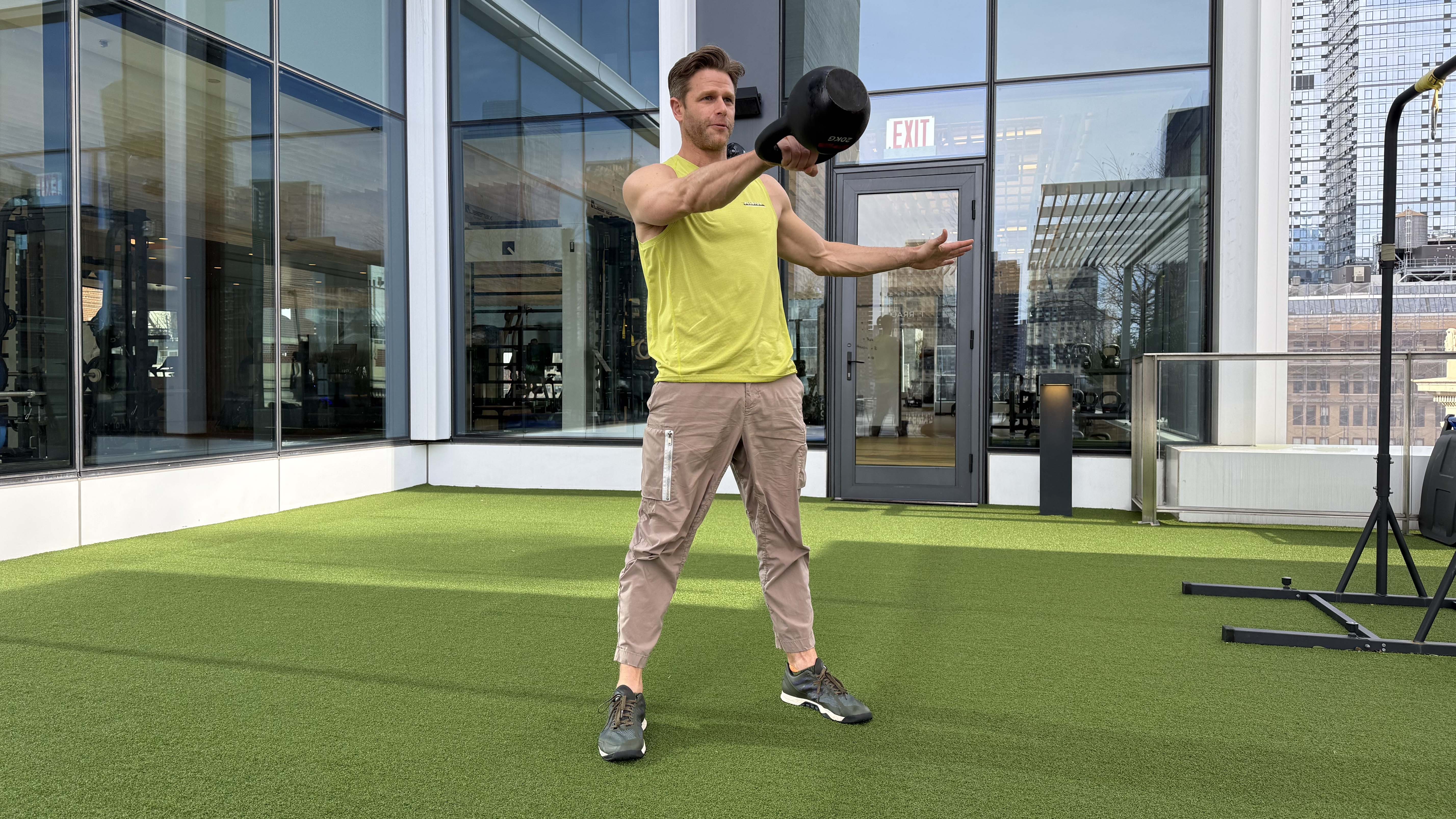 a photo of Peloton trainer Andy Speer doing a kettlebell swing