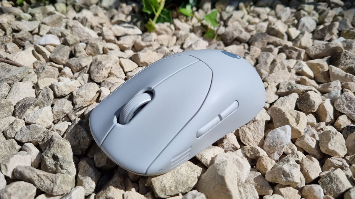 The Alienware Pro Wireless Gaming Mouse on white gravel, on a lovely summers day