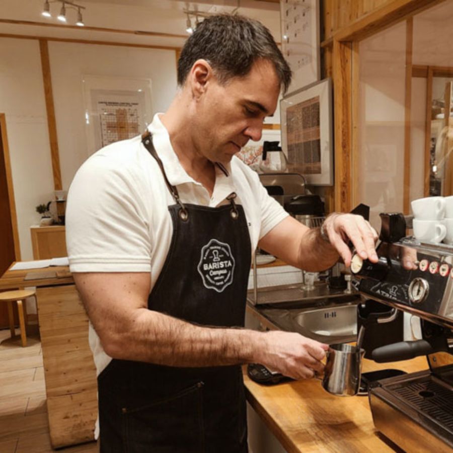 Tom Fontana making a cup of coffee at an espresso machine