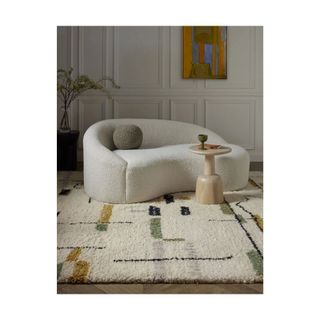 white wool rug with small geometric shapes in color