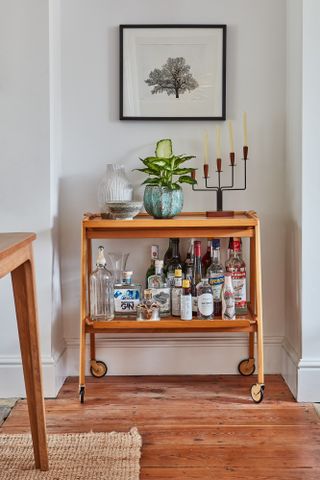 wooden drinks trolley in a living room alcove