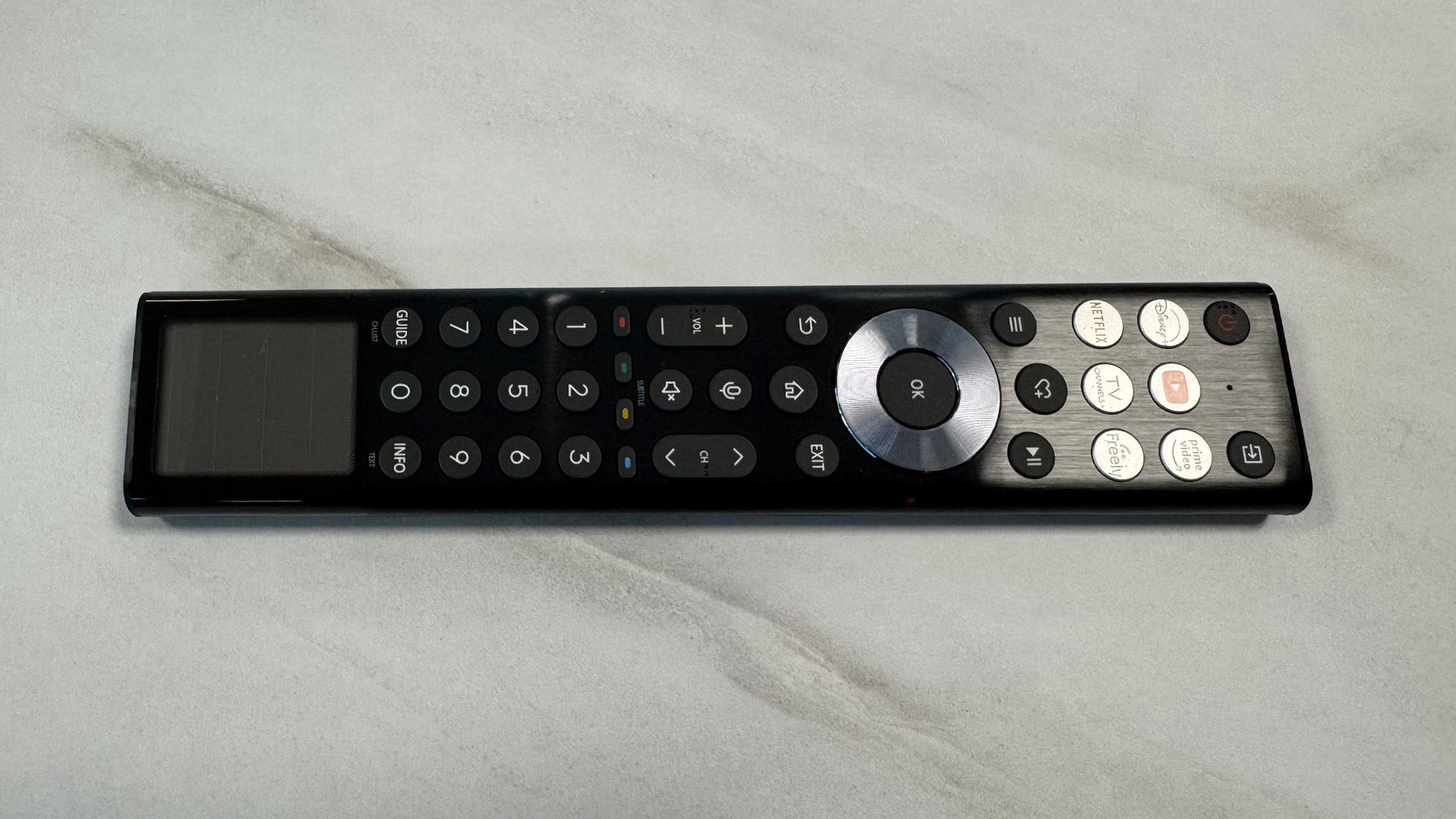 Hisense 116UX RGB Mini LED TV remote control on white marbled surface