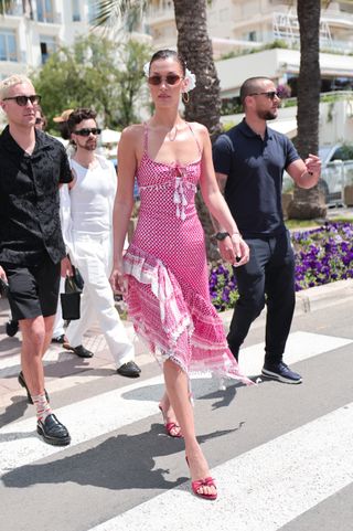 Bella Hadid wears a keffiyeh sundress in Cannes with a flower scrunchie in her hair