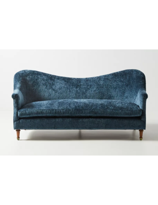 Curved navy blue sofa.
