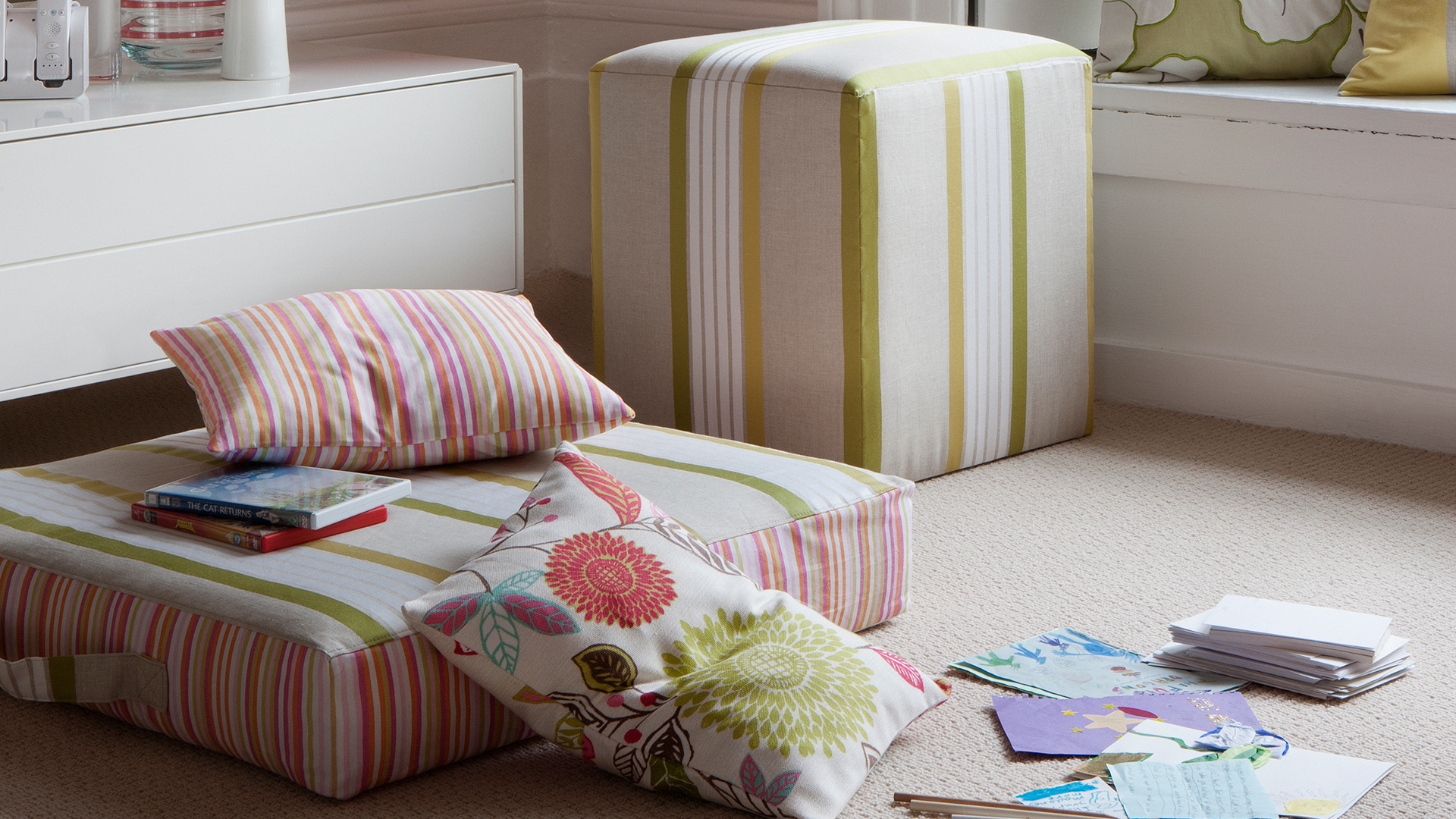 Carpeted living room with floors cushions as additional seating