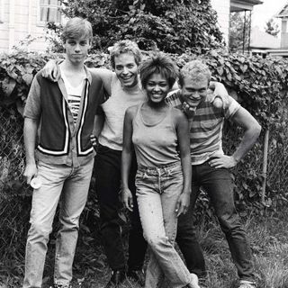 Matt Cameron, Tommy Martin, Tina Bell and Scotty Ledgerwood standing in front of a hedge