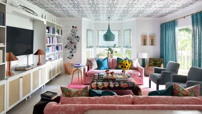 living room with blue walls and patterned sofa