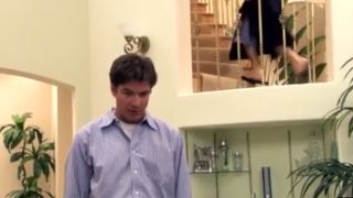 Jason Bateman standing in the living room in the Arrested Development house.