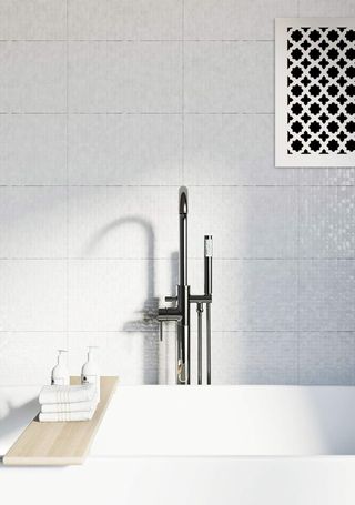 A minimalist white bathroom with an air vent cover