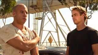 Vin Diesel and Paul Walker standing next to each other in The Fast and the Furious.