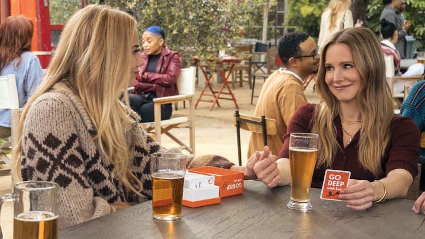 Justine Lupe and Kristen Bell sit at a table drinking beer in Nobody Wants This Season 2.