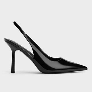 Flat lay image of black patent heels