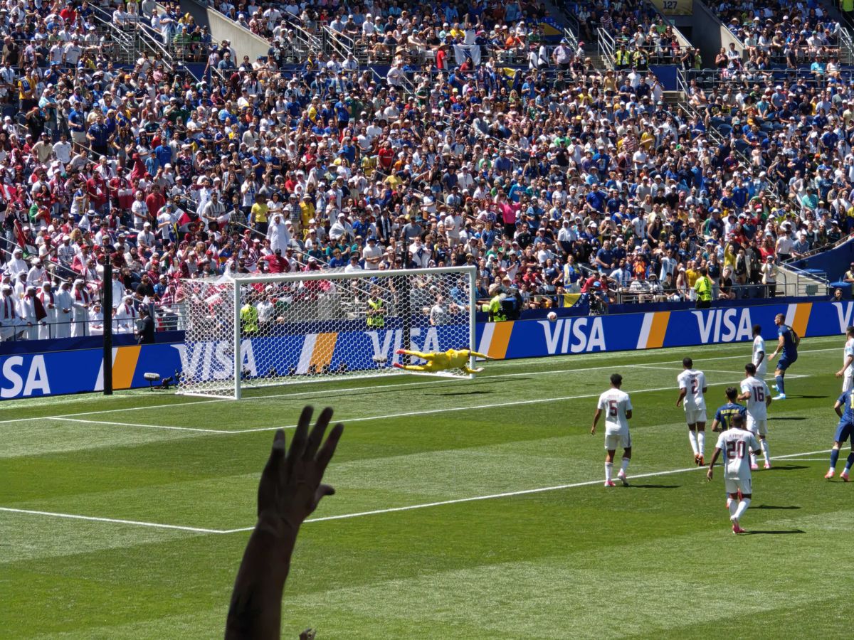 A goalie diving to block a goal