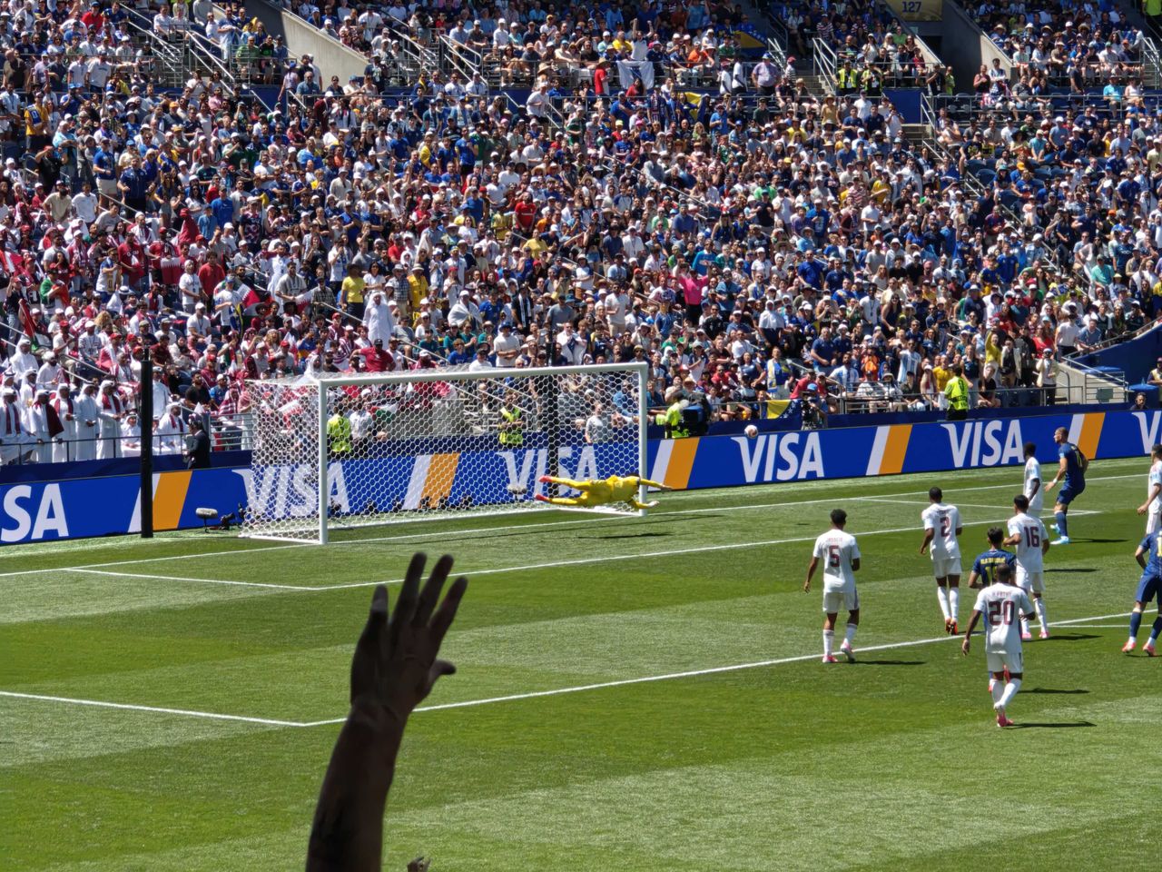 A goalie diving to block a goal