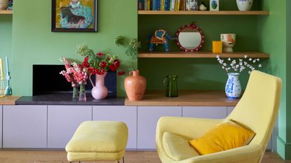 green living room with yellow armchair and open shelves