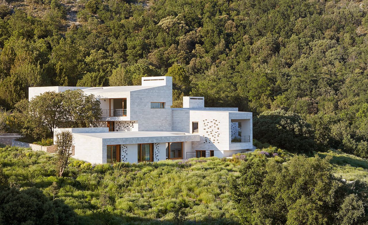 White villa amongst trees &amp; scenery