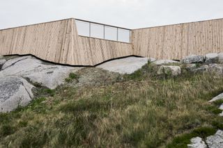 Construction near rocky ground with wooden cladded walls