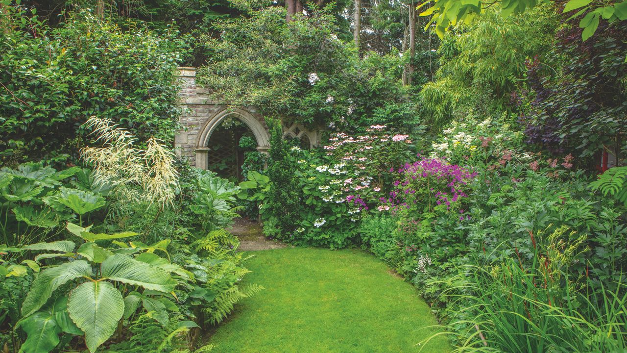 garden with lawn and stone arch