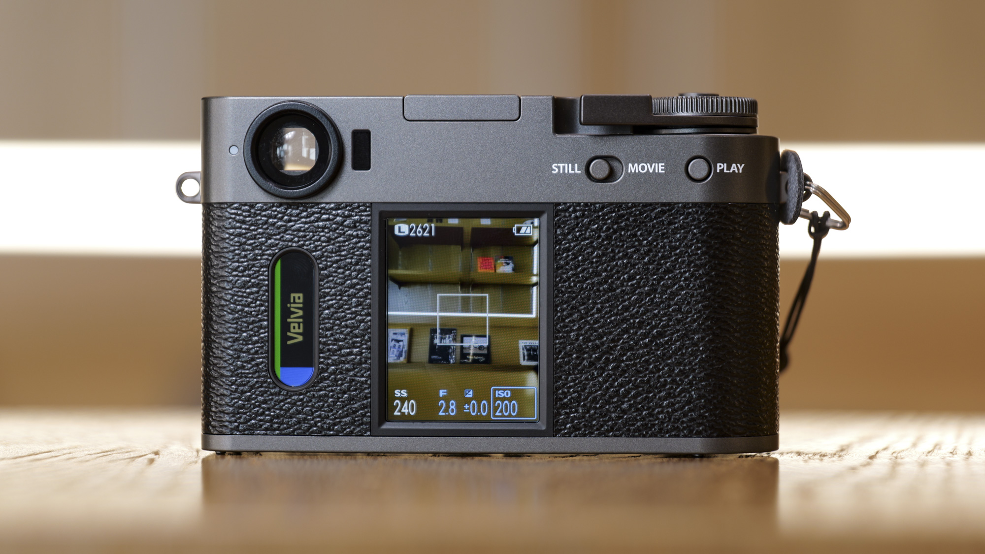 Fujifilm X half compact camera's back, on a wooden surface