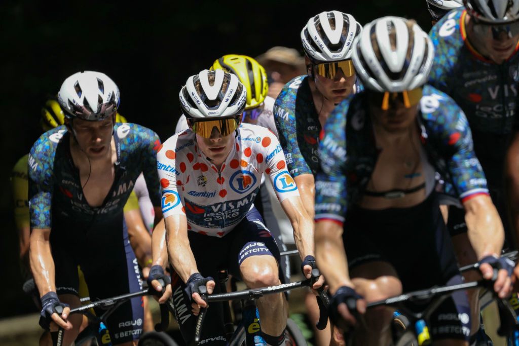 Team Visma - Lease a Bike team's Danish rider Jonas Vingegaard wearing the climber's polka dot (dotted) jersey (second placed in the category) cycles with the pack of riders (peloton) during the 15th stage of the 111th edition of the Tour de France cycling race, 197,7 km between Loudenvielle and Plateau de Beille, in the Pyrenees mountains, southwestern France, on July 14, 2024. (Photo by Thomas SAMSON / AFP)