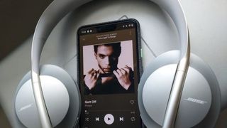 Bose 700 headphones with phone playing Prince's 'Get Off '