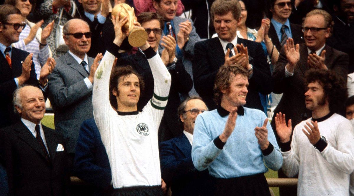 Franz Beckenbauer, captain of West Germany, lifts the FIFA World Cup trophy in 1974.