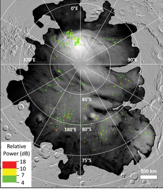 The colored dots represent sites where bright radar reflections have been spotted by ESA’s Mars Express orbiter at Mars’ south polar cap. Such reflections were previously interpreted as subsurface liquid water. Their prevalence and proximity to the frigid surface suggests they may be something else.