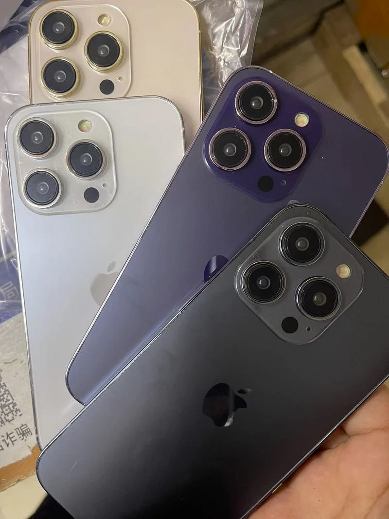 A shot of four iPhone 14 Pro dummy units, in silver, graphite, gold, and purple