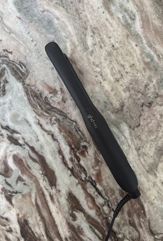 GHD Mini hair straighteners on marble surface