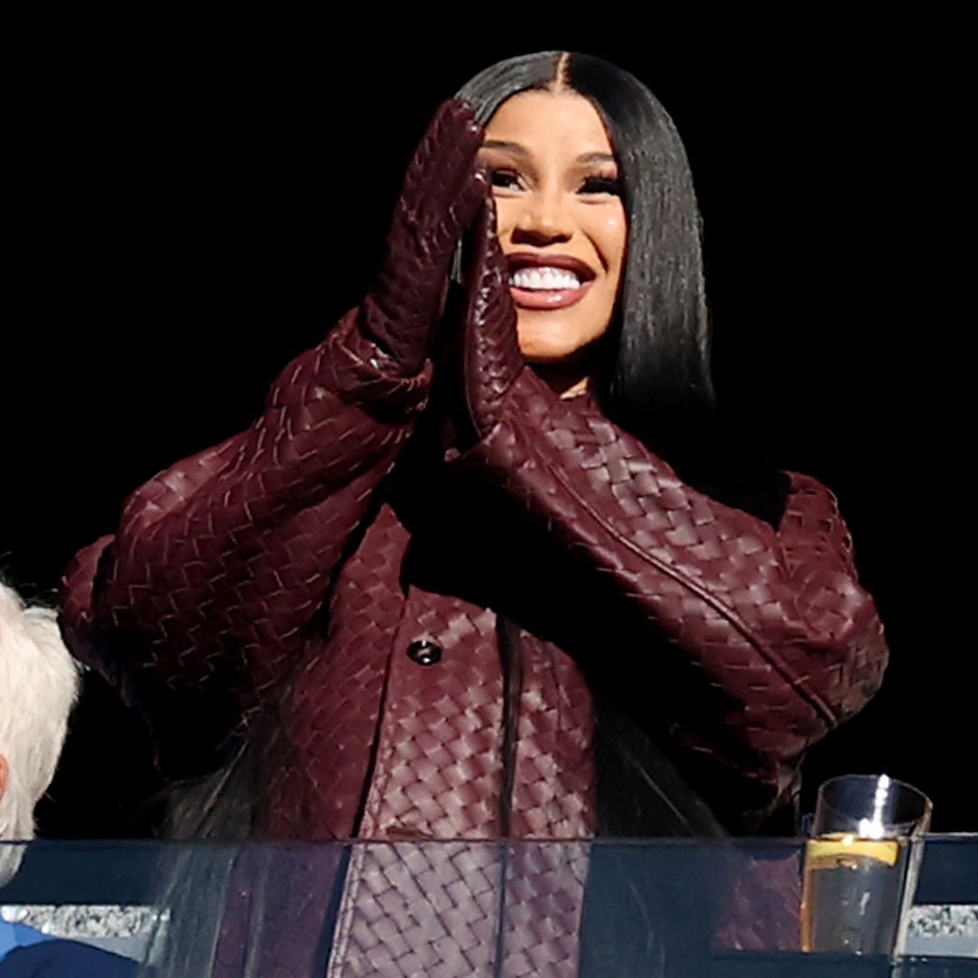 Cardi B attended a New England Patriots football game while wearing a burgundy Bottega Veneta game day outfit