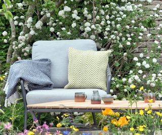 garden chair with cushions and throw