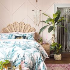Rattan headboard in front of pink bedroom wall panelling ideas