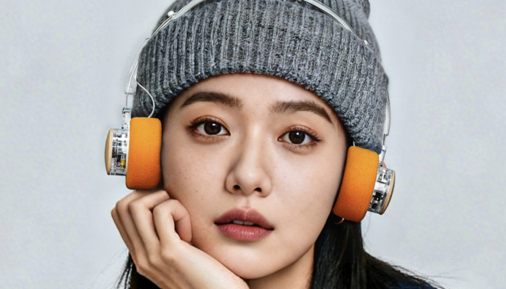 FiiO EH11 worn by a woman wearing a gray beanie hat