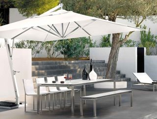 concrete stairs and patio with parasol and furniture from Go Modern